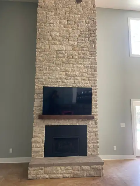 Ledgestone fireplace surround with a wood mantel