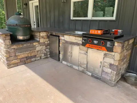 Outdoor kitchen with stainless doors and a griddle