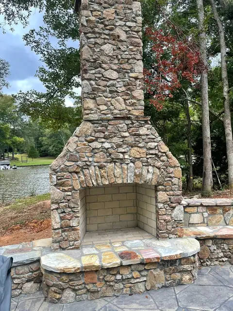 Fieldstone fireplace with a raised stone hearth