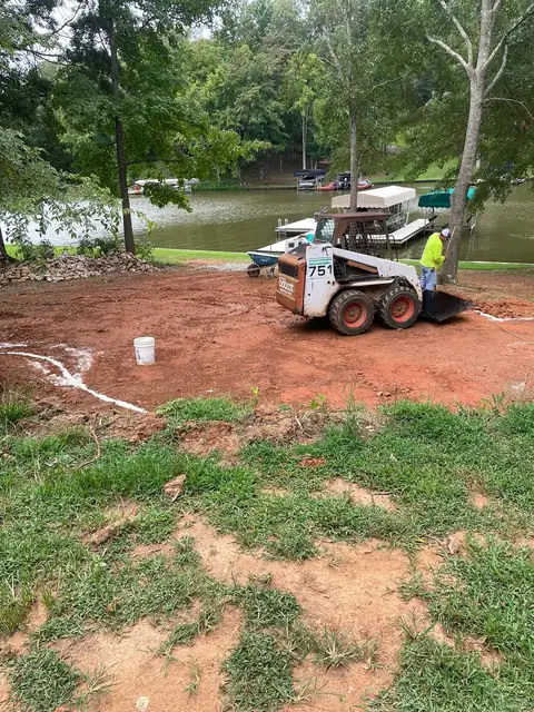 Site before work, with the loader grading the patio area