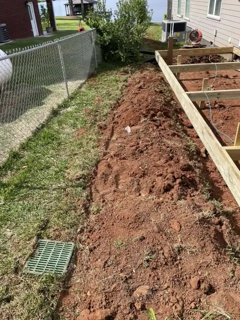Trench for the underground gutter line along the fence
