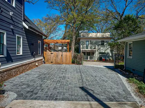 Charcoal paver drive between two houses