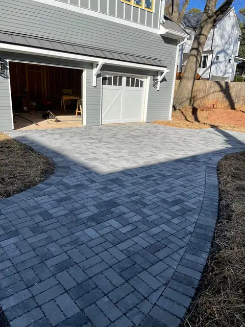 Gray paver apron in front of a garage