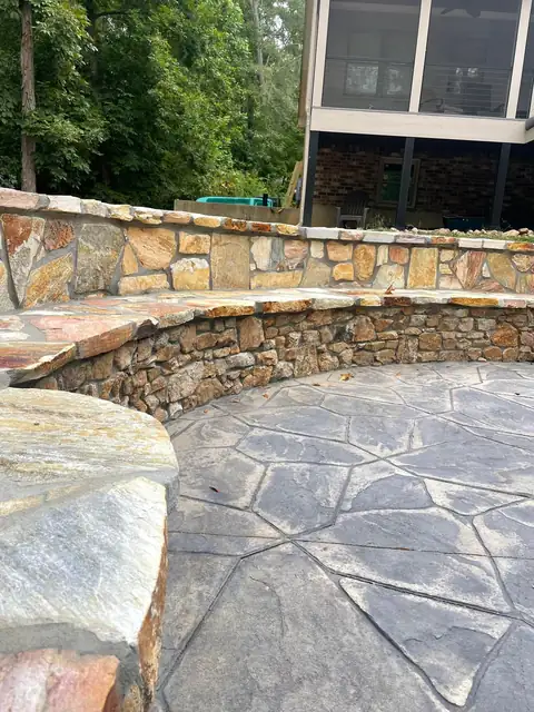 Fieldstone seating wall around a patio